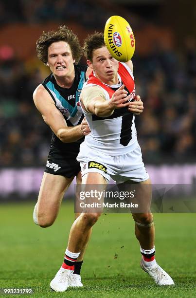 Jack Billings of the Saints under pressure from Jared Polec of Port Adelaide during the round 16 AFL match between the Port Adelaide Power and the St...