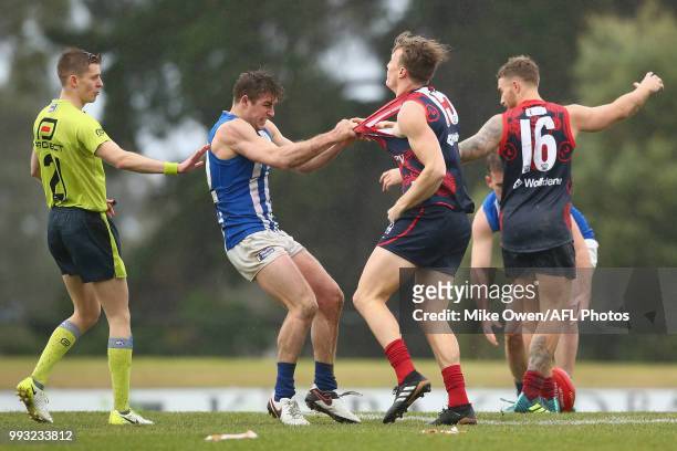 Nash Holmes of the Kangaroos is seen grabing Aaron Vandenberg of the Demons during the round 14 VFL match between Casey and North Melbourne at Casey...