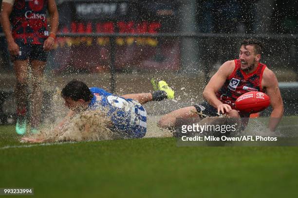 Luke Davies-Uniacke of the Kangaroos and James Munro of the Demons compete for the ball during the round 14 VFL match between Casey and North...