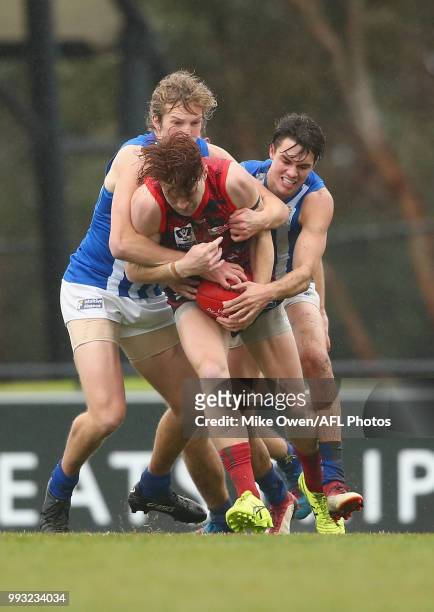 Oskar Baker of the Demons is tackled during the round 14 VFL match between Casey and North Melbourne at Casey Fields on July 7, 2018 in Melbourne,...