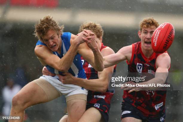 Oscar Junker of the Kangaroos is tackled during the round 14 VFL match between Casey and North Melbourne at Casey Fields on July 7, 2018 in...
