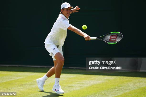 Sebastian Korda of the United States returns a shot during his Boys' Singles first round match on day six of the Wimbledon Lawn Tennis Championships...