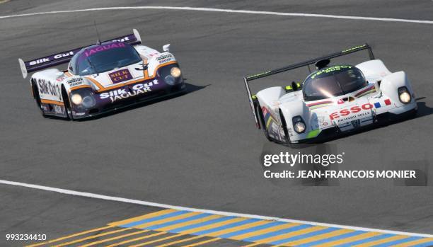 French's driver Dominique Guenat competes in his Peugeot 905 EV1 1993 ahead British's driver Shaun Lynn on his JAGUAR XJR-9 1987 during a race,...