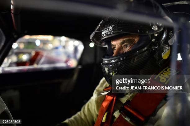 Former French Prime Minister Francois Fillon awaits in his 1965s Lotus Elan prior a practice session, amongst 44 other Prototype Le Mans Group C...