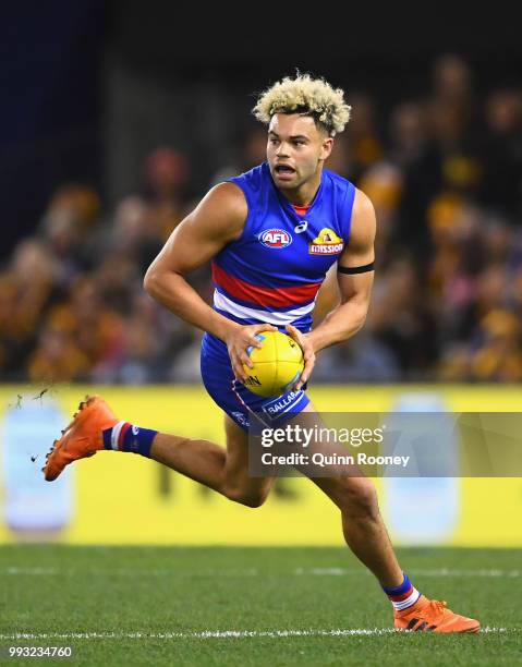 Jason Johannisen of the Bulldogs looks to pass the ball during the round 16 AFL match between the Western Bulldogs and the Hawthorn Hawks at Etihad...