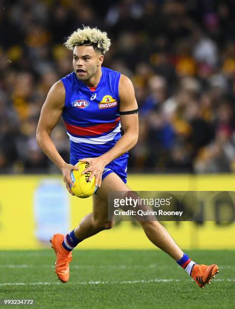 Jason Johannisen of the Bulldogs looks to pass the ball during the round 16 AFL match between the Western Bulldogs and the Hawthorn Hawks at Etihad...