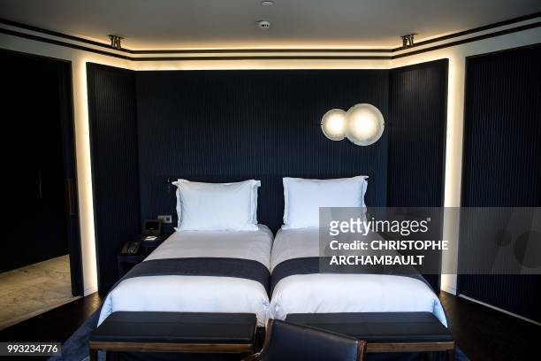 This picture shows beds in a junior suite of the newly-refurbished Lutetia Hotel in Paris on July 6, 2018. - The iconic, history steeped Lutetia...