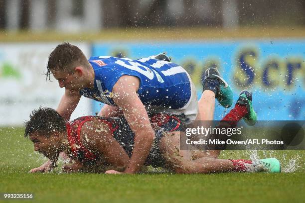 Jay Kennedy-Harris of the Demons and Louis Cunningham of the Kangaroos compete for the ball during the round 14 VFL match between Casey and North...