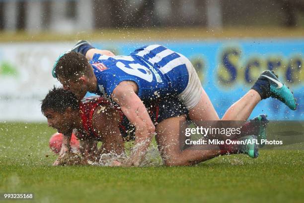 Jay Kennedy-Harris of the Demons and Louis Cunningham of the Kangaroos compete for the ball during the round 14 VFL match between Casey and North...