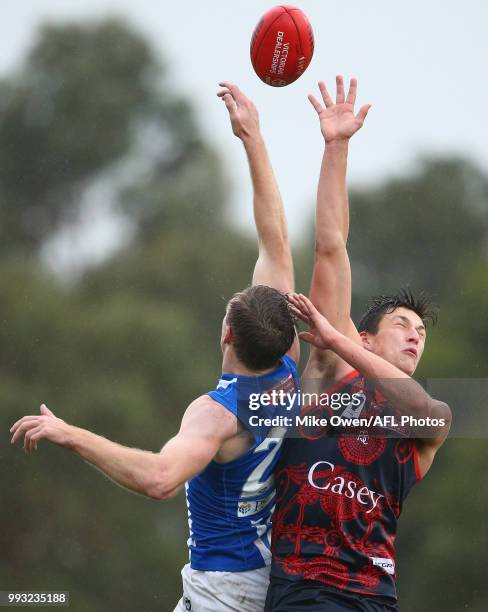 Sam Durdin of the Kangaroos and Samuel Weideman of the Demons compete for the ball during the round 14 VFL match between Casey and North Melbourne at...