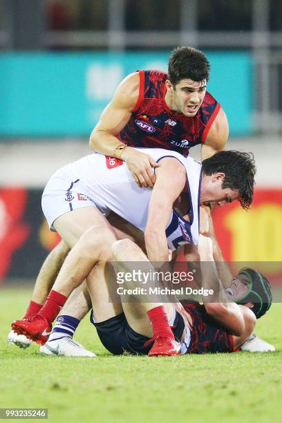 Andrew Brayshaw of the Dockers wrestles on top of brother Angus Brayshaw of the Demons after a contest during the round 16 AFL match between the...