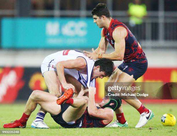 Andrew Brayshaw of the Dockers wrestles on top of brother Angus Brayshaw of the Demons after a contest during the round 16 AFL match between the...