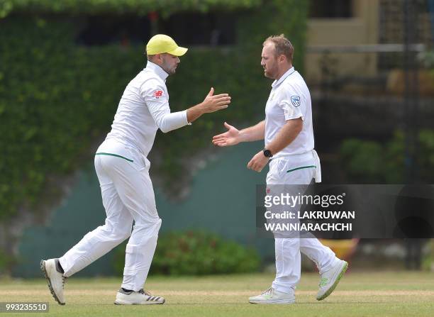 Shaun von Berg of South Africa celebrates with his teammate Aiden Markram after dismissing Dhananjaya de Silva of Sri Lanka Board XI during the...