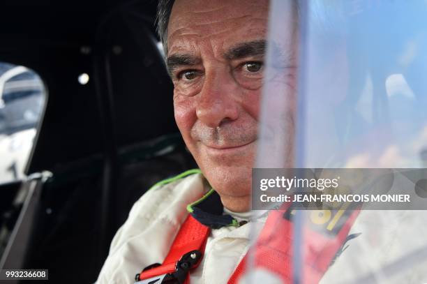 Former French Prime Minister Francois Fillon waits in his 1965 Lotus Elan prior to a practice session with 76 other cars dating from 1962- 1965,...