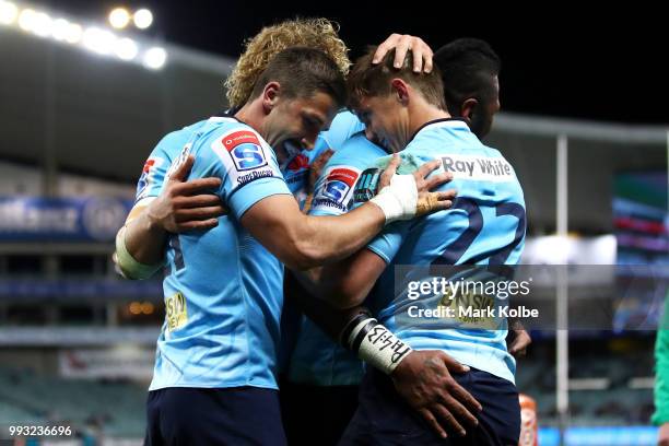 Bryce Hegarty of the Waratahs celebrates with his team mates after scoring a try during the round 18 Super Rugby match between the Waratahs and the...