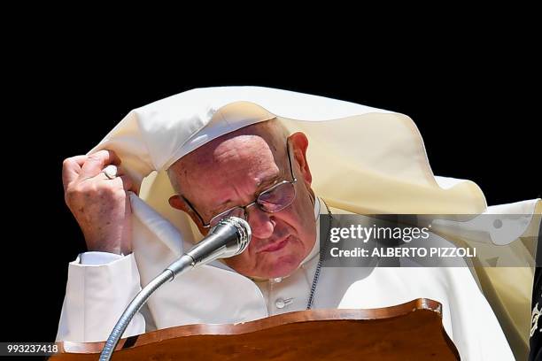 Gust of wind blows Pope Francis' cape as he delivers his speech after a meeting with religious leaders at the Pontifical Basilica of St Nicholas in...