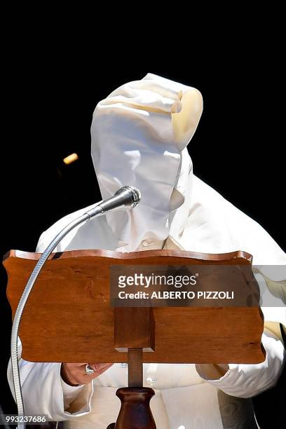 Gust of wind blows Pope Francis' cape as he delivers his speech after a meeting with religious leaders at the Pontifical Basilica of St Nicholas in...