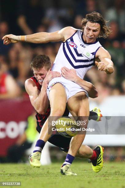 Sam Frost of the Demons tackles Ed Langdon of the Dockers during the round 16 AFL match between the Melbourne Demons and the Fremantle Dockers at TIO...