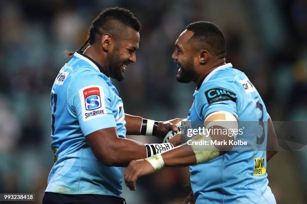 Taqele Naiyaravoro of the Waratahs celebrates with his team mate Sekope Kepu of the Waratahs after scoring a try during the round 18 Super Rugby...