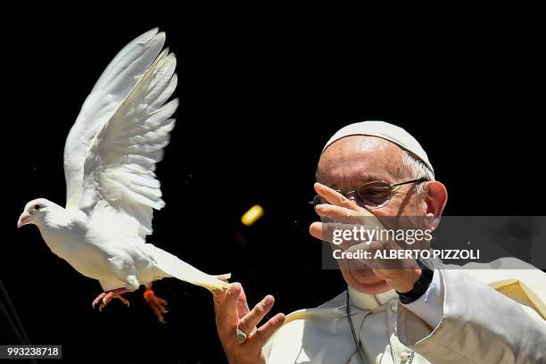 Pope Francis releases a dove after a meeting with other religious leaders at the Pontifical Basilica of St Nicholas in Bari, in the Apulia region in...