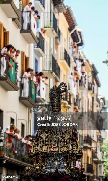 People attend the the procession of Pamplona´s patron Saint Fermin on the first day of the San Fermin bull run festival in Pamplona, northern Spain...