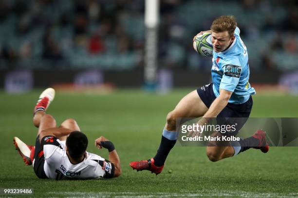 Cameron Clark of the Waratahs is tackled during the round 18 Super Rugby match between the Waratahs and the Sunwolves at Allianz Stadium on July 7,...