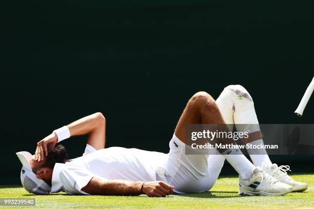 Benoit Paire of France reacts after falling to the court against Juan Martin del Potro of Argentina during their Men's Singles third round match on...