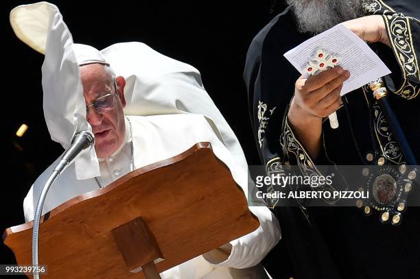 Gust of wind blows Pope Francis' cape as he delivers his speech after a meeting with religious leaders at the Pontifical Basilica of St Nicholas in...