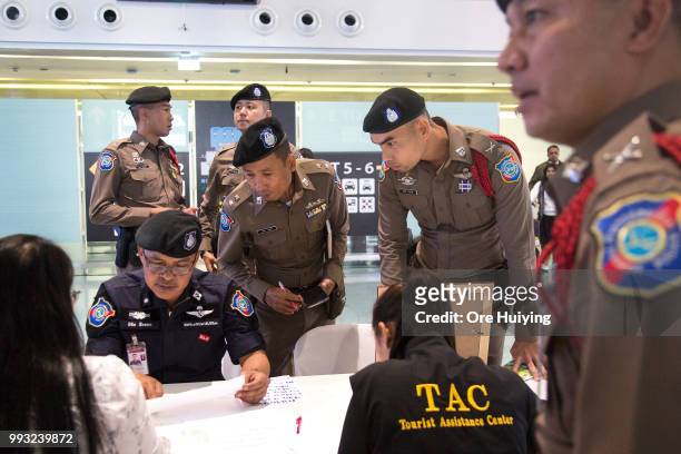 Thai officials and volunteers set up a reception area at the Phuket airport for the arrival of family members of passengers onboard a capsized...