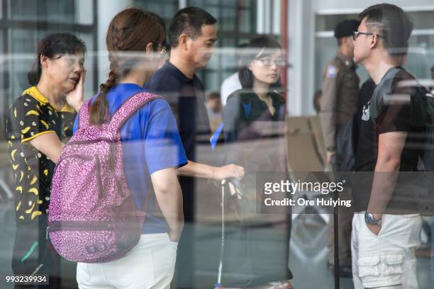 Family members of passengers onboard a capsized tourist boat wait at Phuket Airport upon their arrival on July 7, 2018 in Phuket, Thailand. At least...