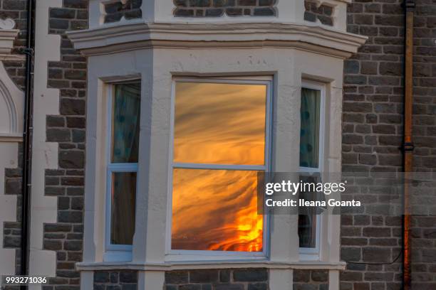 sunset reflection in the window - ileana stock pictures, royalty-free photos & images