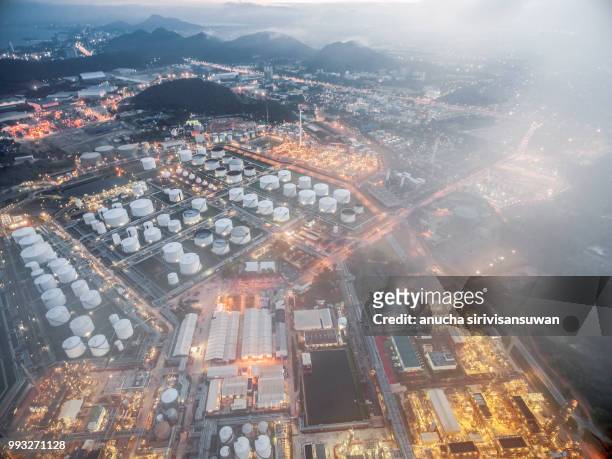 aerial top view oil refinery at night, thailand. - tank top stock-fotos und bilder