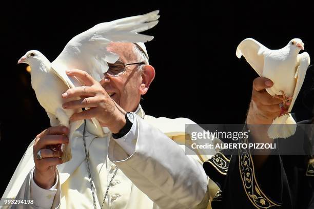 Pope Francis releases a dove after a meeting with other religious leaders at the Pontifical Basilica of St Nicholas in Bari, in the Apulia region in...