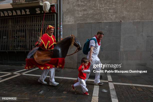 Zaldiko' chases a child during the Comparsa de Gigantes y Cabezudos, or Giants and Big Heads parade on the second day of the San Fermin Running of...