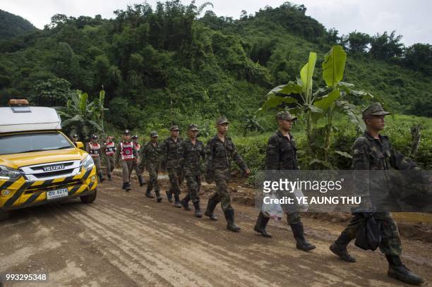 Thai soldiers and police walks to Tham Luang cave area as rescue operation continues for the 12 boys and their football team coach trapped in the...
