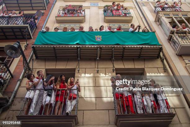 Revellers watch the San Fermin procession on the second day of the San Fermin Running of the Bulls festival on July 7, 2018 in Pamplona, Spain. The...