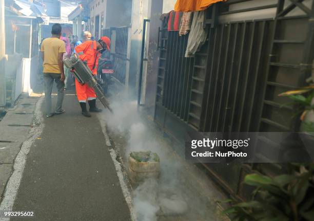 Akarta health workers fogged the crowded residential street and narrow alley in Bukit Duri, Jakarta, in July 2018. The fumigation to anticipate and...