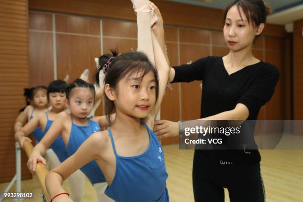 Children attend basic dance training at a dance training center on July 4, 2018 in Xiangyang, Hubei Province of China. Many Chinese children in...