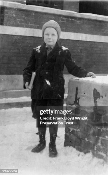 Llewellyn Wright standing next to brick pier in front of Studio entrance after 1911 renovations made the Studio into the family home, at the Frank...