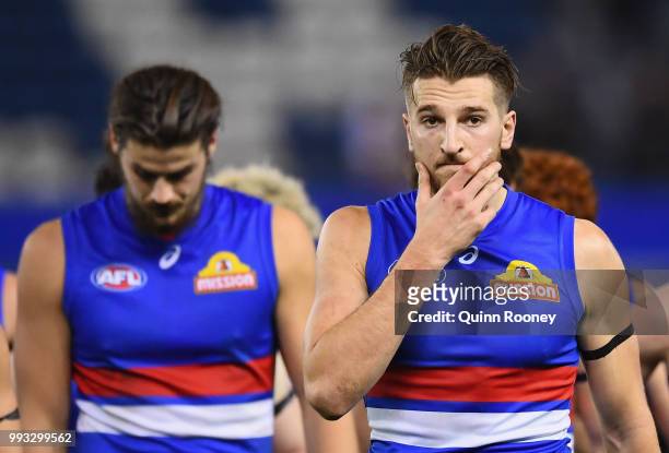 Marcus Bontempelli and his Bulldogs team mates look dejected after losing the round 16 AFL match between the Western Bulldogs and the Hawthorn Hawks...