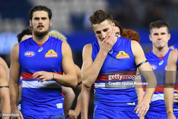 Marcus Bontempelli and his Bulldogs team mates look dejected after losing the round 16 AFL match between the Western Bulldogs and the Hawthorn Hawks...