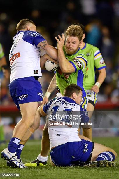 Elliott Whitehead of the Raiders is tackled during the round 17 NRL match between the Canterbury Bulldogs and the Canberra Raiders at Belmore Sports...