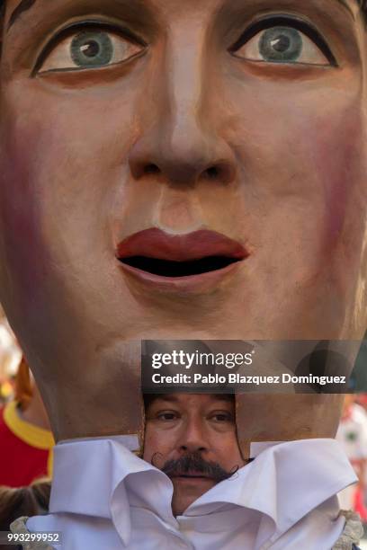 Man performs as a Kiliki during the Comparsa de Gigantes y Cabezudos, or Giants and Big Heads parade on the second day of the San Fermin Running of...