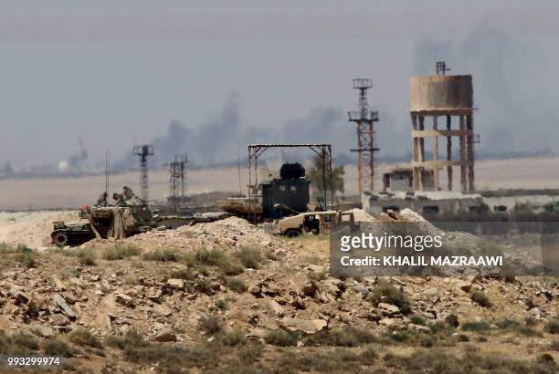 General view taken from the Jordanian Mafraq governate on July 7 shows military vehicle across the border in Syria, a day after Syrian government...