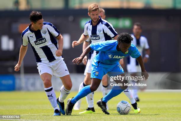 Shaq Coulthirst of Barnet in action with Gareth Barry and Martin Cranie of West Bromwich Albion during the Pre-season friendly between Barnet and...