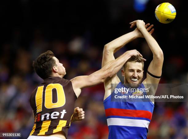 Jaeger O'Meara of the Hawks and Marcus Bontempelli of the Bulldogs compete for the ball during the 2018 AFL round 16 match between the Western...