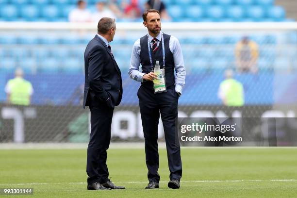 Gareth Southgate, Manager of England talks to his assistant Aidy Boothroyd during pitch inspection prior to the 2018 FIFA World Cup Russia Quarter...