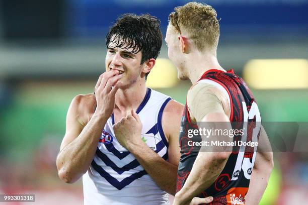 Defeated Andrew Brayshaw of the Dockers talks gestures to his teeth with Clayton Oliver of the Demons during the round 16 AFL match between the...