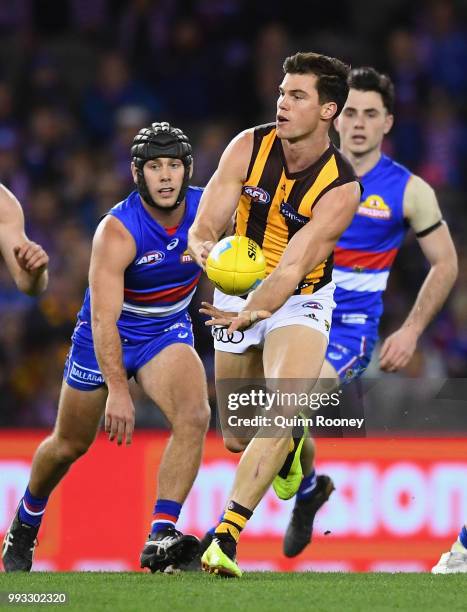 Jaeger O'Meara of the Hawks handballs during the round 16 AFL match between the Western Bulldogs and the Hawthorn Hawks at Etihad Stadium on July 7,...