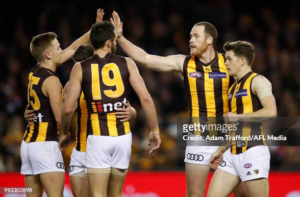 Jarryd Roughead of the Hawks celebrates with Harry Morrison, Luke Breust, Jack Gunston and Taylor Duryea of the Hawks during the 2018 AFL round 16...